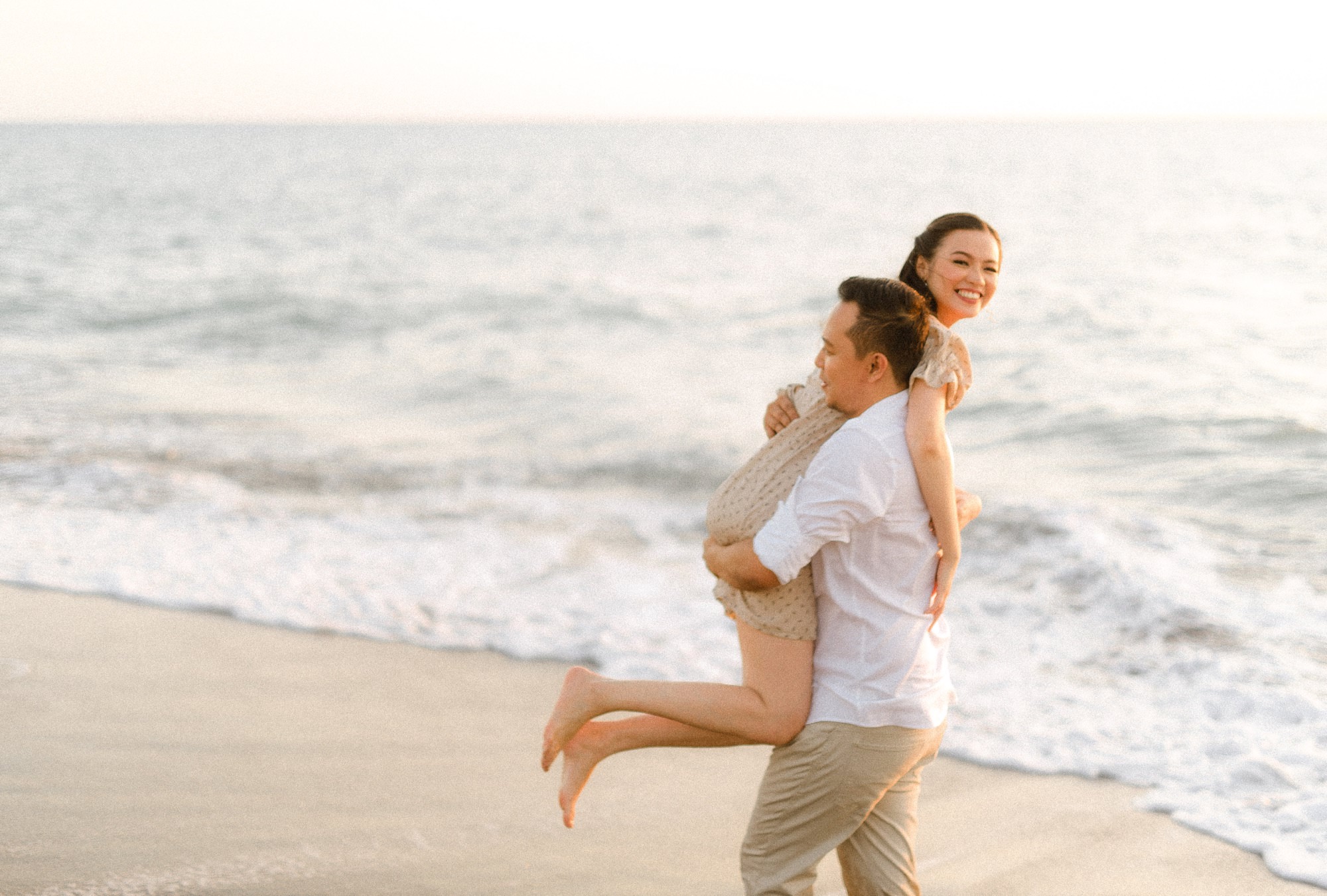 Guy carrying the girl during their prenup shoot